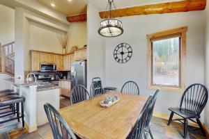 a kitchen and dining room with a wooden table and chairs at The Antlers 401 in Winter Park