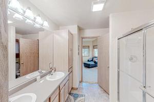a bathroom with two sinks and a shower at Hemlock Cabin in Granby +25 photos