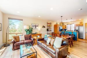 a living room with leather furniture and a dining room at WinterStar E-2 in Fraser