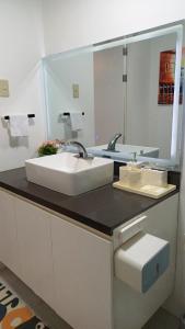 a bathroom with a sink and a mirror at Cai Residence - Stylish 2BR Staycation near EK & Tagaytay Gateway in Santa Rosa +62 photos