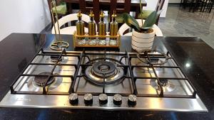a stove top oven with a pot on top of it at Cai Residence - Stylish 2BR Staycation near EK & Tagaytay Gateway in Santa Rosa
