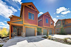 a large wooden house with a garage at Buffalo Lodge Townhomes 1293 in Silverthorne