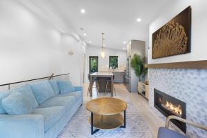 a living room with a blue couch and a fireplace at Saratoga Beach Villa 4 in Oyster Bay