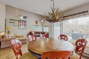 a living room with a dining room table and chairs at Vail Valley Condo in Edwards