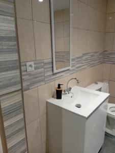 a bathroom with a white sink and a toilet at Tour de bridier in La Souterraine +23 photos