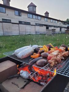a grill with some meat and vegetables on it at The Yurts at Margo's Garden, Kiroro in Shiribeshi