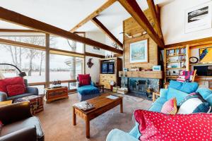 a living room with blue couches and a fireplace at The Director's Cabin in Teton Village