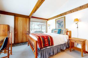 a bedroom with a bed and a window at The Director's Cabin in Teton Village