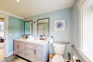 a bathroom with a toilet and a sink and a mirror at The Farmhouse - Suite #1 in Waterbury +57 photos