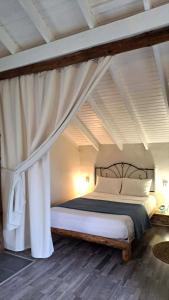 a bedroom with a bed with a canopy at Studio ISABEL in Sálakos