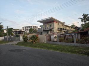 a house with a fence in front of a street at 77 Fulaga Flats in Suva