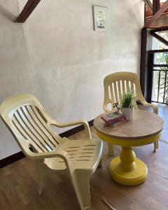 two chairs and a table in a room at Amancio's Tourist Inn-Close to the Airport in Puerto Princesa City