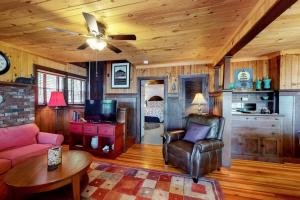 a living room with a couch and a ceiling fan at Highland Playhouse in Windham