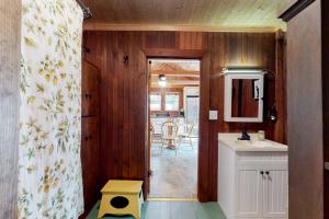 a bathroom with a sink and a door to a kitchen at Highland Playhouse in Windham +64 photos