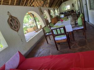 a room with a table and chairs in a room at Cave House in Kilifi