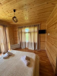 a bedroom with a bed in a wooden room at Ivlita in Mestia