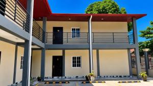 a large white building with a red roof at hotel harmony in El Edén +6 photos