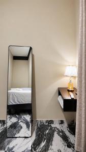 a bedroom with a mirror and a bed at hotel harmony in El Edén