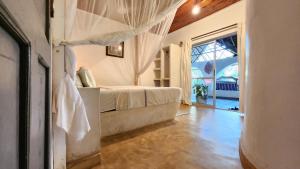 a bedroom with a bed and a couch in a room at Cave House in Kilifi +38 photos