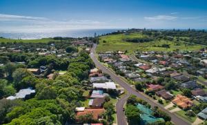 an overhead view of a suburb with a road and the ocean at Pandanus Studio Lennox Head in Lennox Head +4 photos