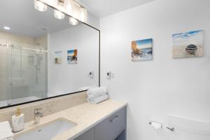 a bathroom with a sink and a mirror at Saratoga Beach Villa 4 in Oyster Bay +24 photos