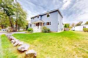 a blue house with a grassy yard at Coastal Gem in York
