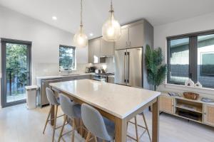 a kitchen with a table and chairs in it at Saratoga Beach Villa 4 in Oyster Bay