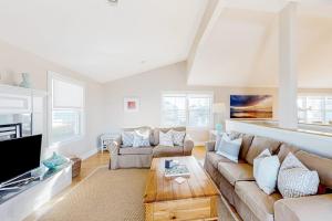 a living room with a couch and a tv at Sunset View in Wells