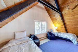a attic bedroom with two beds and a window at Kamp Kota in Belgrade