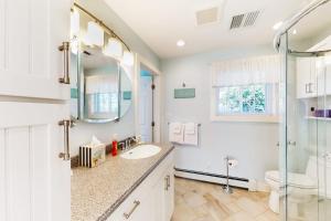 a white bathroom with a sink and a shower at Eastwind Elegance in Ogunquit +42 photos