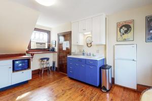 a kitchen with blue cabinets and a white refrigerator at Morning on the Atlantic in Portland