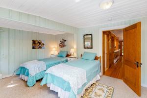 two beds in a bedroom with blue and white at Lakefront Retreat in Naples