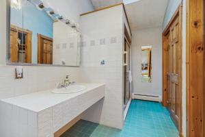 a white bathroom with a sink and a mirror at Camp on Brandy in Naples +57 photos
