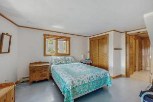 a bedroom with a bed and a wooden dresser at Camp on Brandy in Naples