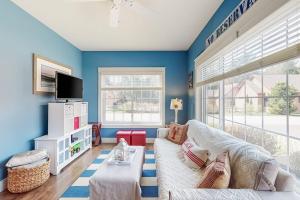 a living room with blue walls and a white couch at Wells Wonder in Wells
