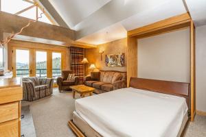 a bedroom with a bed and a living room at Shoshone 1993 in Big Sky +66 photos
