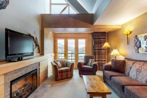 a living room with a couch and a fireplace at Shoshone 1993 in Big Sky