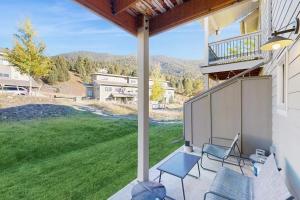 a porch with chairs and a view of a yard at Morning Sun 2061B in Big Sky