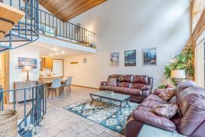 a living room with a couch and a table at Ptarmigan in Whitefish