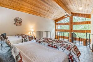 two beds in a room with a large window at Ptarmigan in Whitefish +90 photos