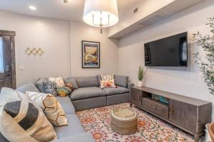 a living room with a couch and a flat screen tv at The Electric Bungalow in Bigfork