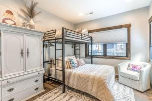 a bedroom with a bunk bed and a chair at The Electric Bungalow in Bigfork
