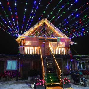 a house with christmas lights on the roof at Sameer Mountain View Cottage in Tanah Rata