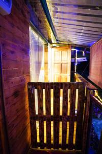 a wooden bench sitting in the middle of a room at Sameer Mountain View Cottage in Tanah Rata
