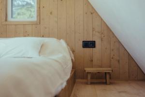 a bedroom with a bed and a clock on the wall at A Házikó in Balatonederics