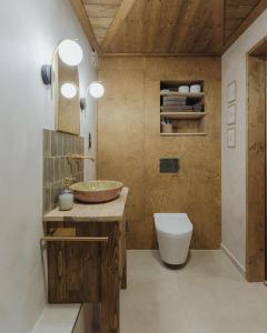 a bathroom with a toilet and a sink at A Házikó in Balatonederics