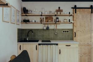 a kitchen with a sink and a counter top at A Házikó in Balatonederics +17 photos