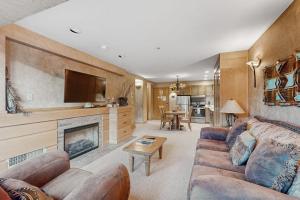 a living room with a couch and a fireplace at Shoshone 1917 in Big Sky