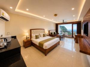 a hotel room with a bed and a balcony at The Moksh DA Hotel A Premium Property Near Jaypee Hotel in Mussoorie +41 photos
