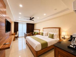 a hotel room with a bed and a television at The Moksh DA Hotel A Premium Property Near Jaypee Hotel in Mussoorie